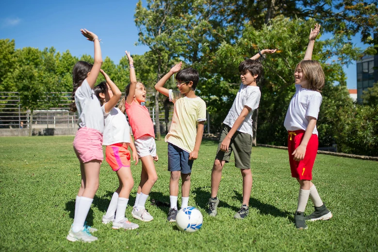 Children viving each other a high-five.