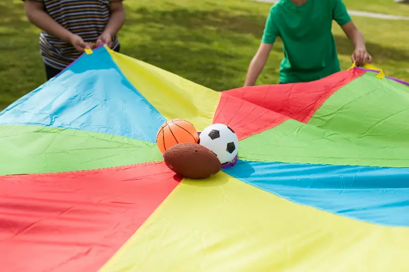 Parachute with various balls on top.