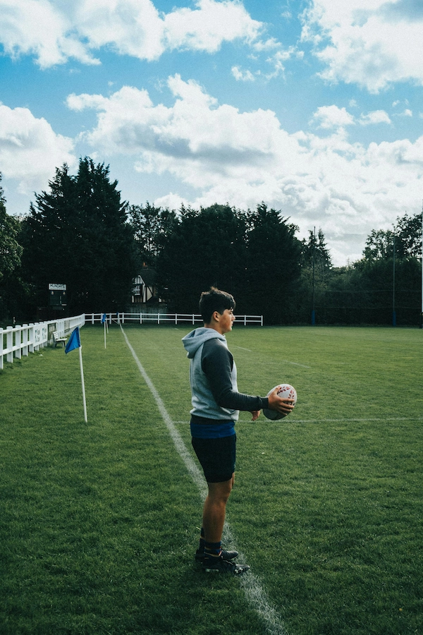 Player preparing to throw a rugby ball.